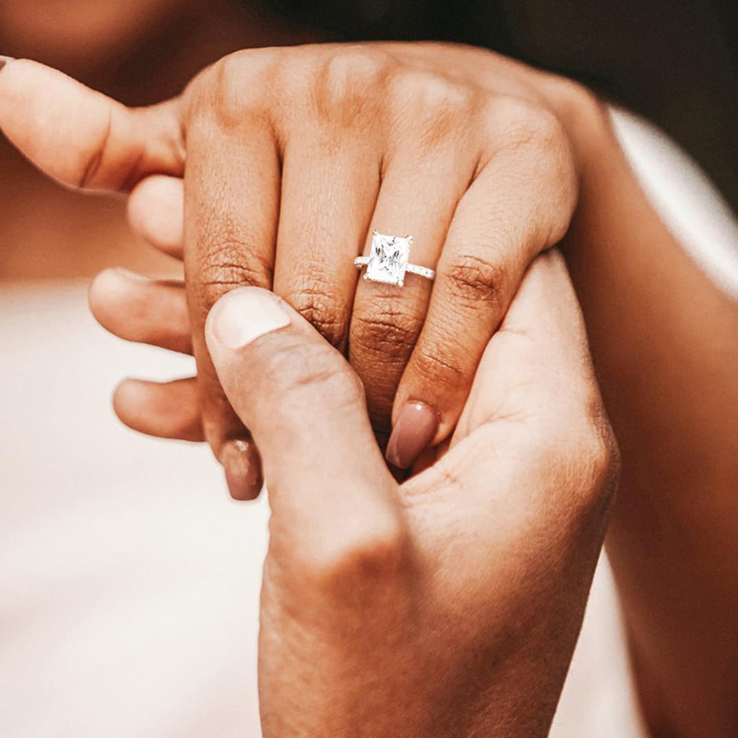 Close-up of a hand wearing a rectangular diamond edge ring, promise ring for women