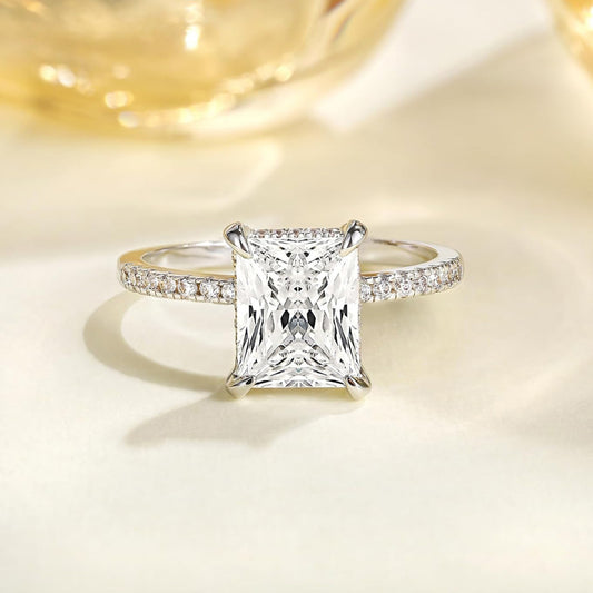 Close-up of gold rectangular white diamond four-prong ring, detailed band design, trendy light luxury jewelry for women