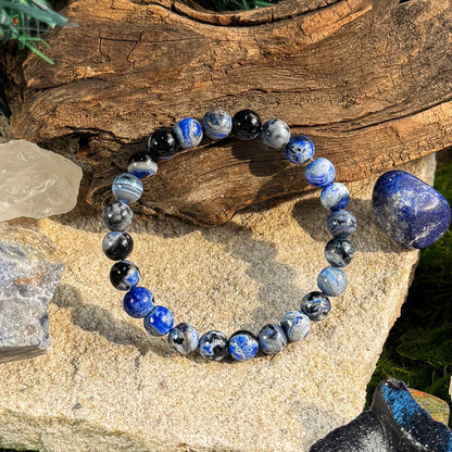 Blue agate yoga bracelet in yoga pose setting, wellness jewelry for meditation practice
