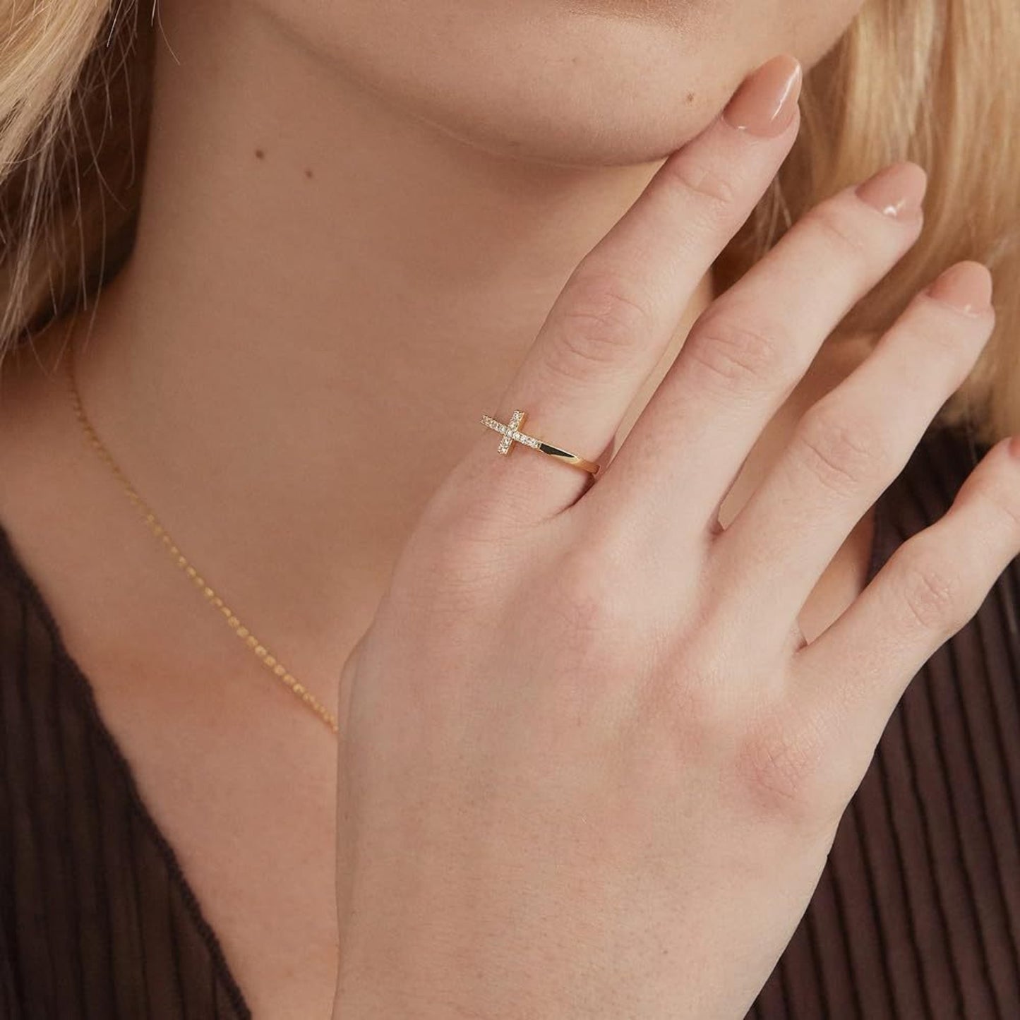 Model wearing cross ring, elegant faith-inspired jewelry for women