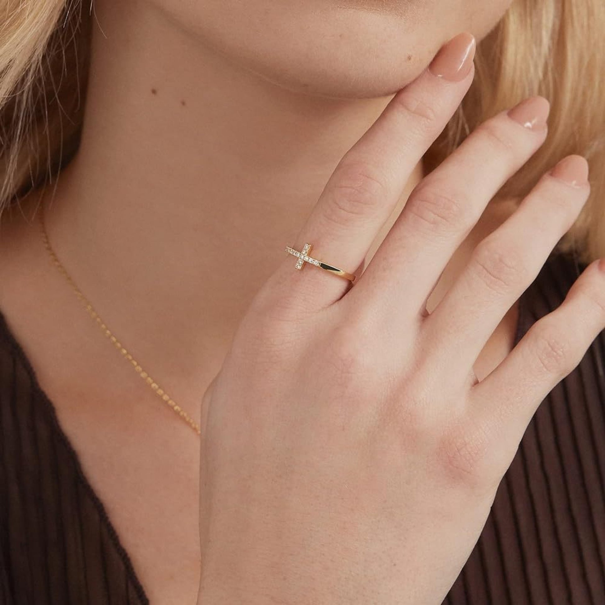Model wearing cross ring, elegant faith-inspired jewelry for women