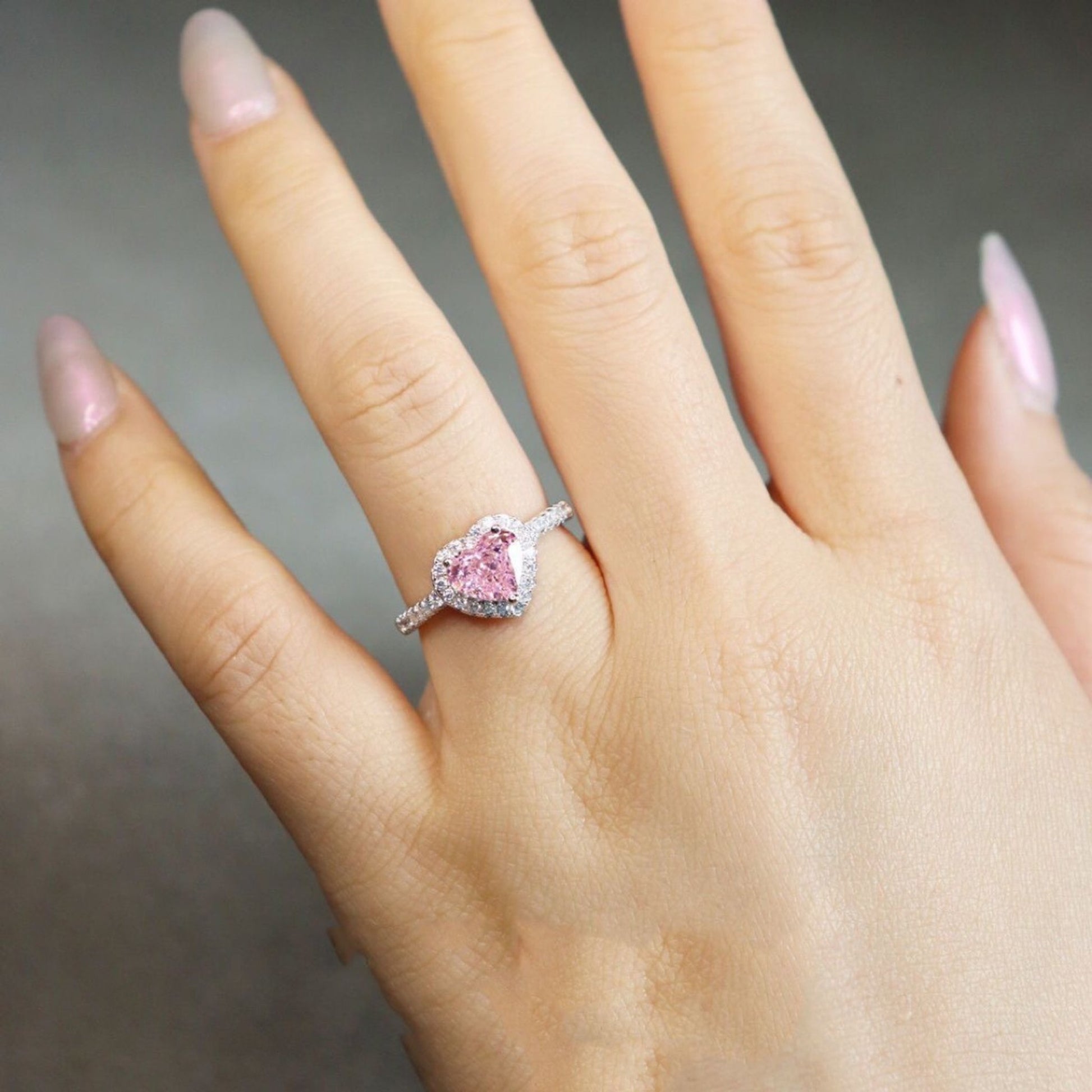 Closeup of pink heart CZ ring on finger, daily wear jewelry, sygjewelry
