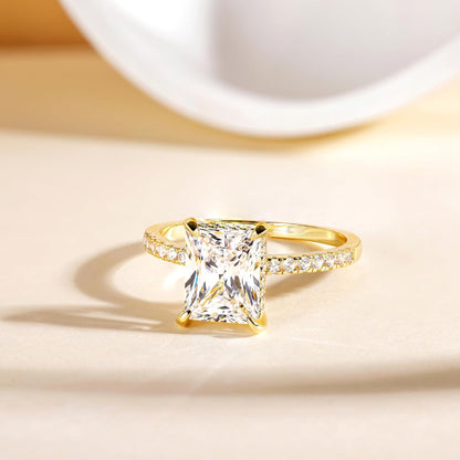 Side view of gold rectangular white diamond four-prong ring, sparkling band design, trendy fashion jewelry for women