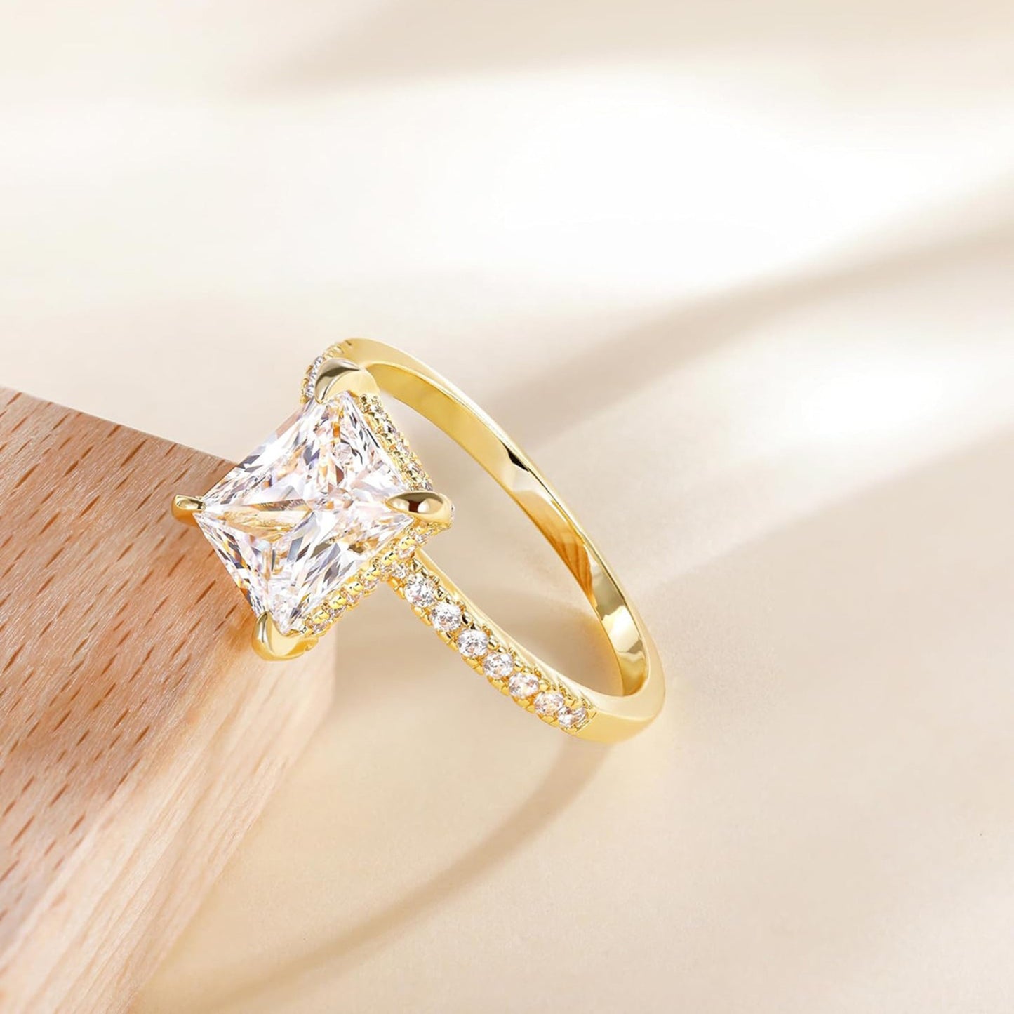 Rose gold rectangular white diamond four-prong ring, mirror reflection close-up, luxury engagement ring for women