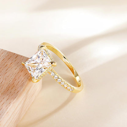 Rose gold rectangular white diamond four-prong ring, mirror reflection close-up, luxury engagement ring for women